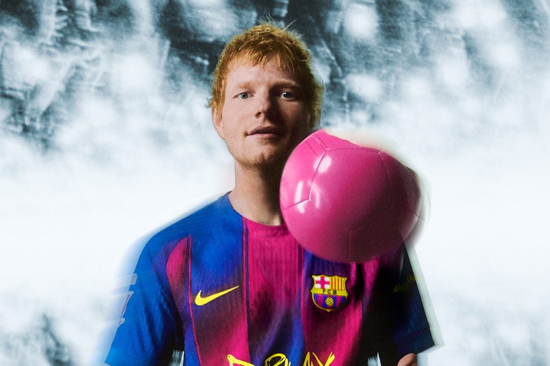 English singer-songwriter Ed Sheeran wears a special edition of the FC Barcelona jersey with his Play album logo