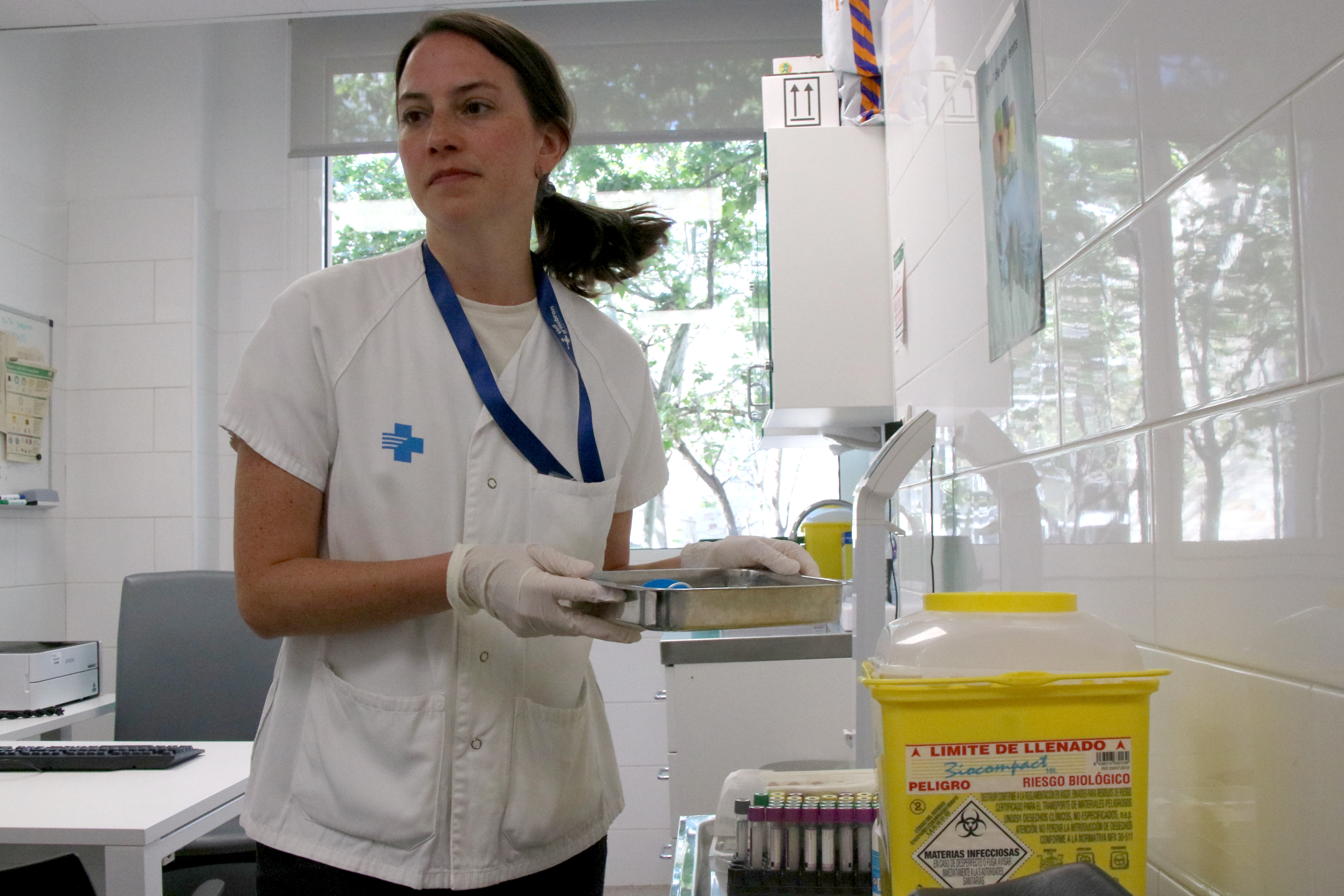 A nurse collects samples from a clinic for testing