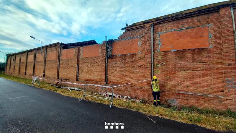 Firefighters review the state of a house in Flaçà, northeastern Catalonia, where the roof has already fallen