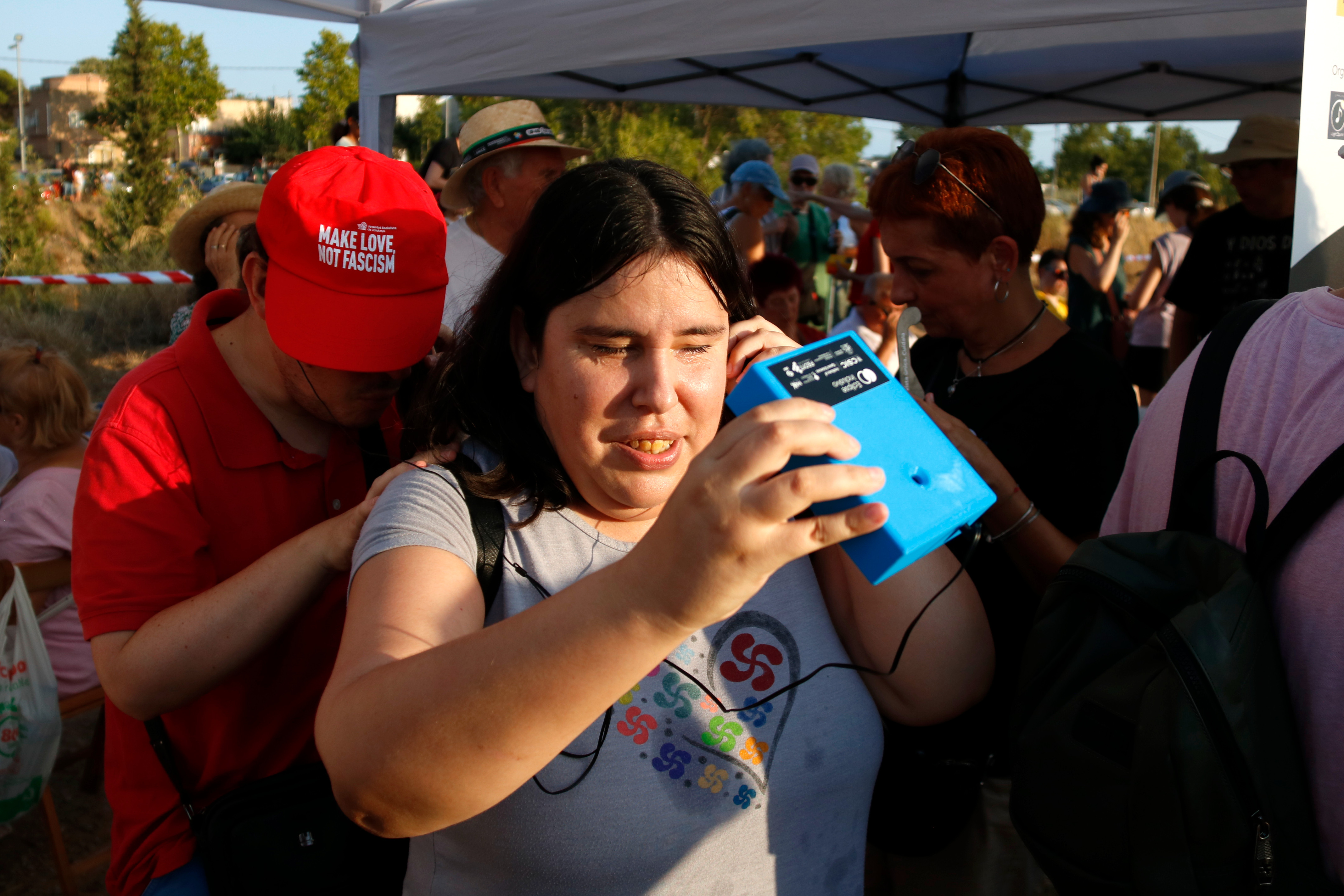 A visually impaired woman follows the eclipse using a LightSound device in Reus