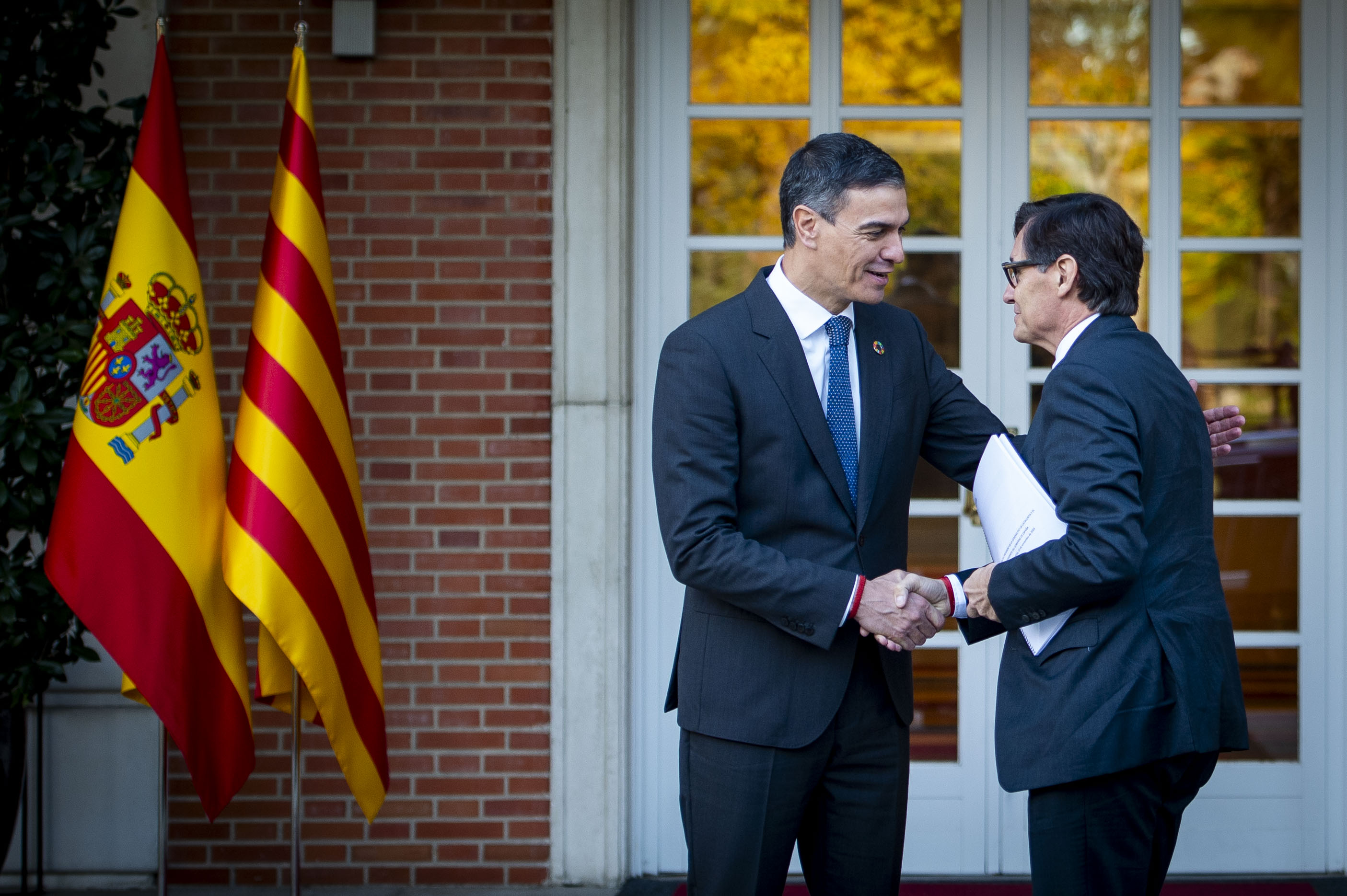 Catalan president Salvador Illa greets Spanish PM Pedro Sánchez ahead of a meeting in La Moncloa, Spain's government headquarters in Madrid, on November 22, 2024