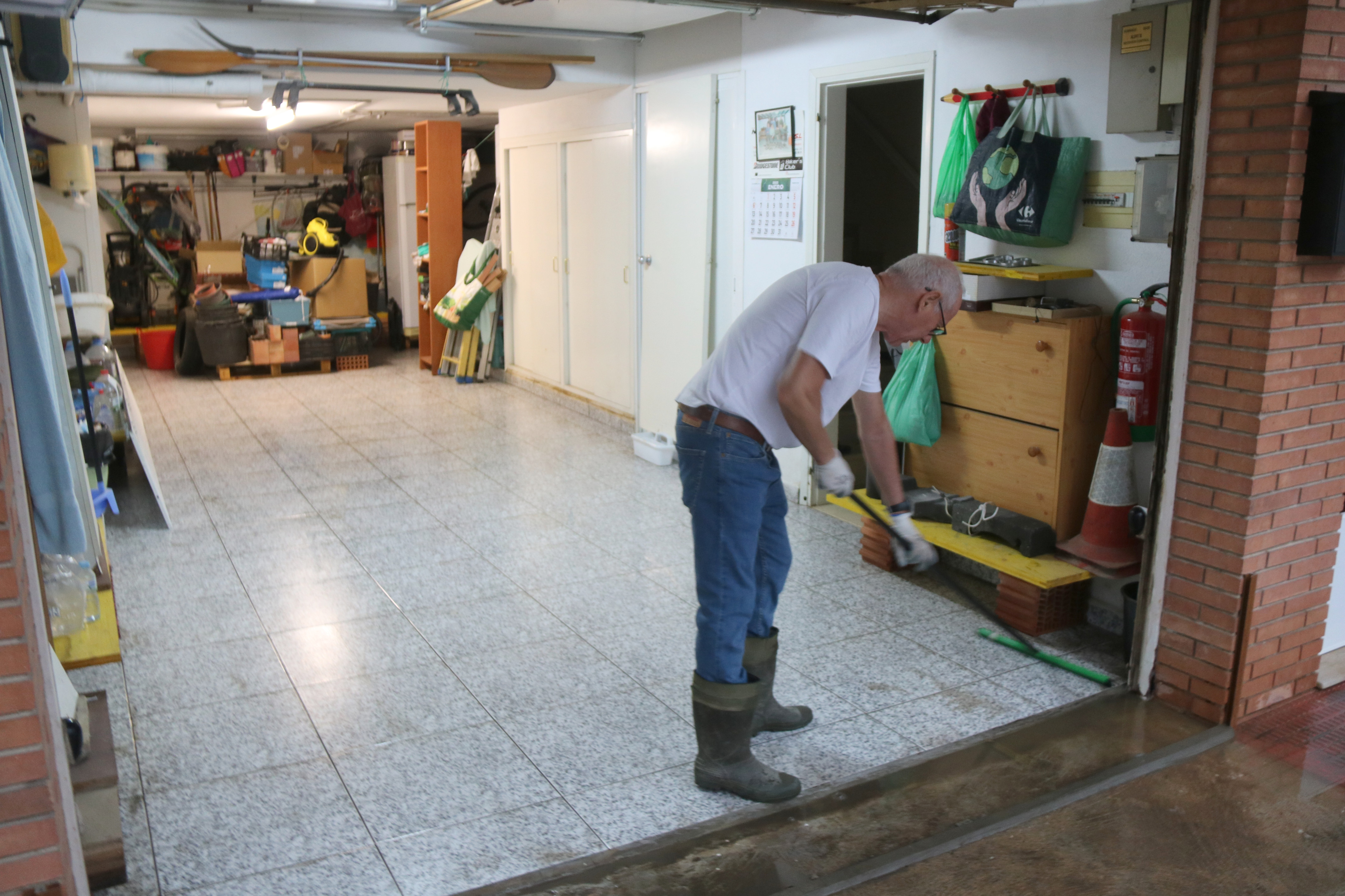 Marc Conesa, one of the residents in Amposta, cleaning his warehouse after it was flooded on September 29, 2025