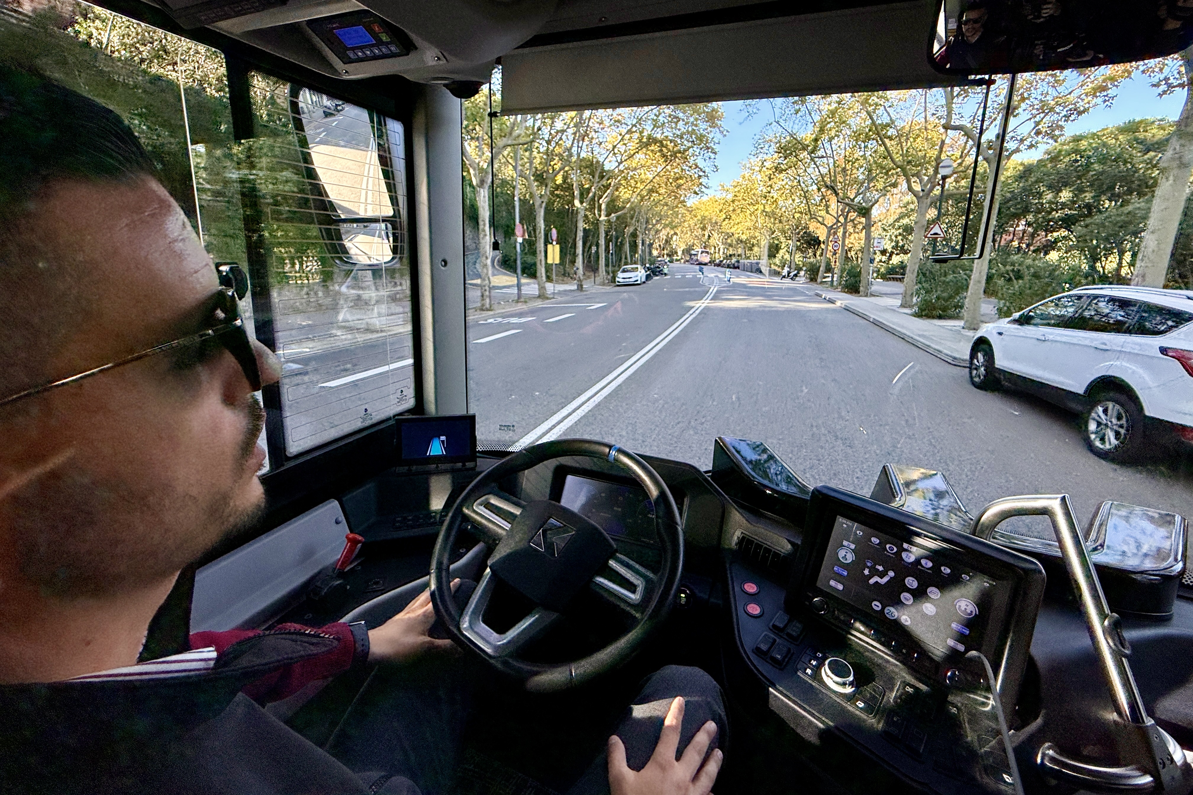 A TMB bus driver controls the self-driving bus during a loop route across Barcelona's Montjuïc Mountain