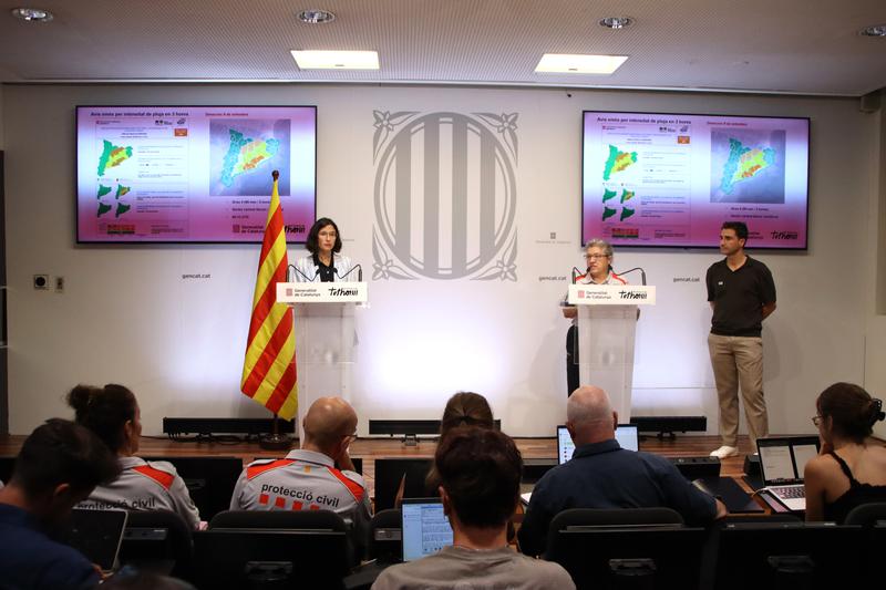 Catalan interior minister and civil protection authorities speaking at a press conference
