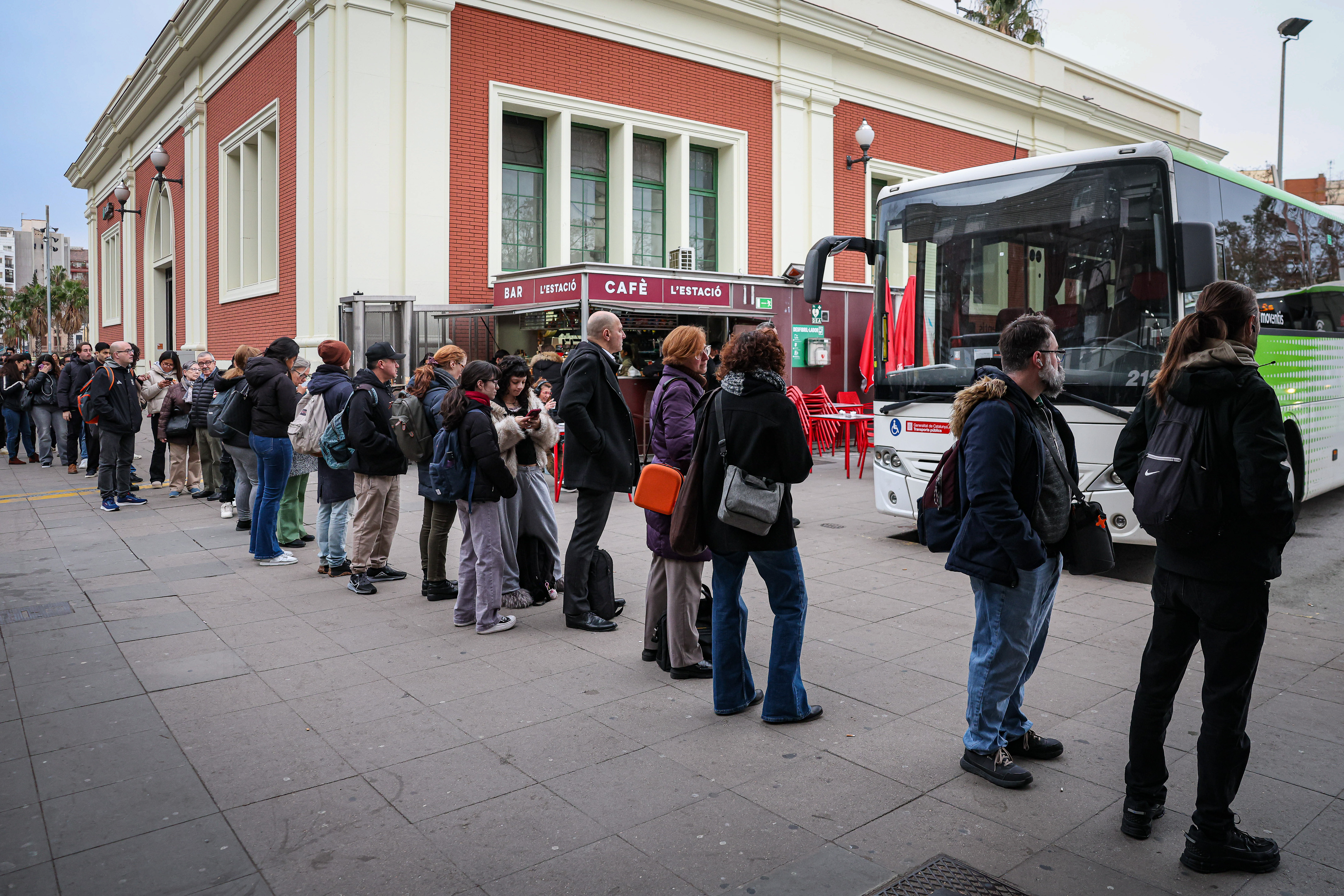 Passengers queue for the bus outside Fabra i Puig Rodalies station