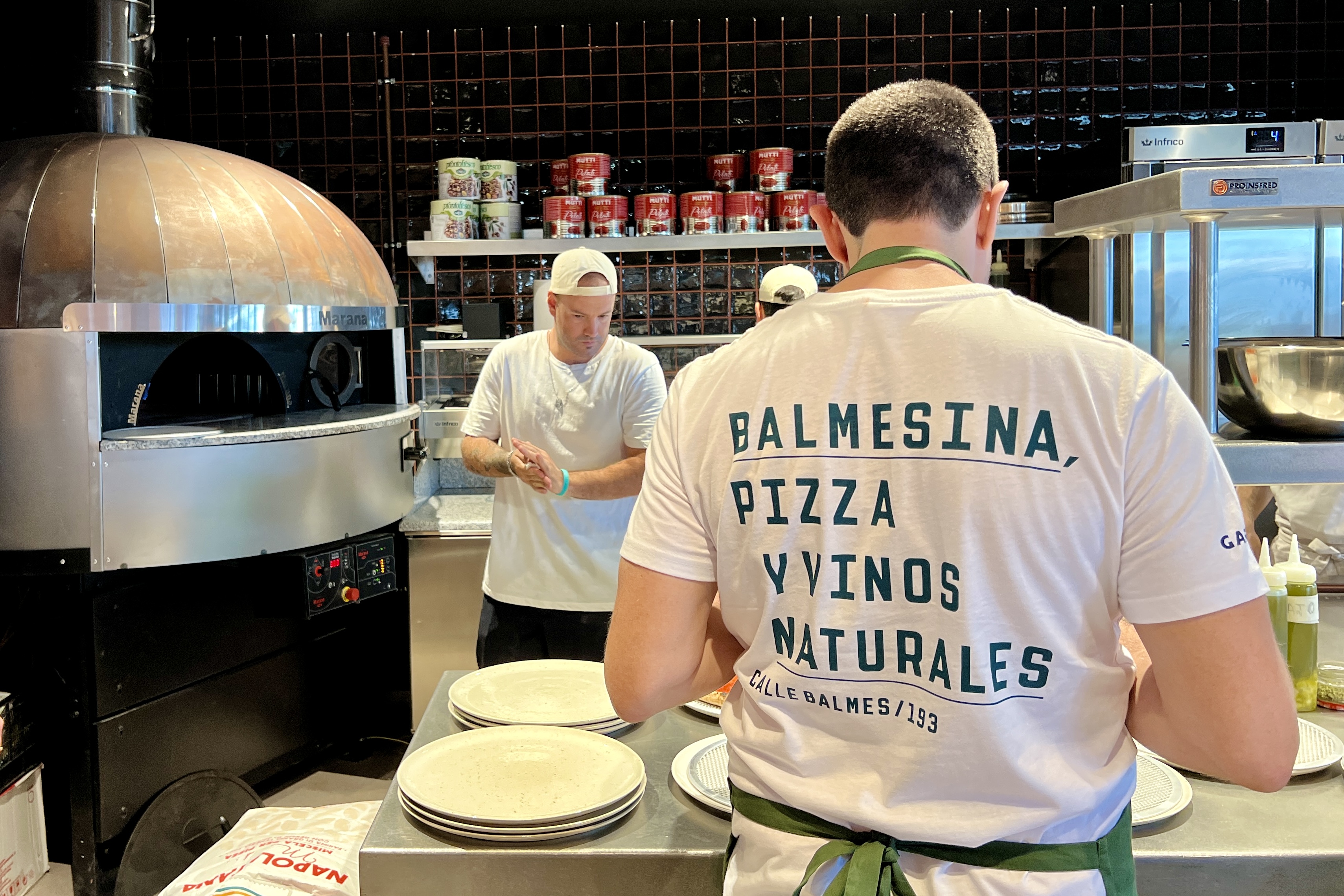 Some chefs at the La Balmesina food stand at the TimeOut Market Barcelona on July 3, 2024