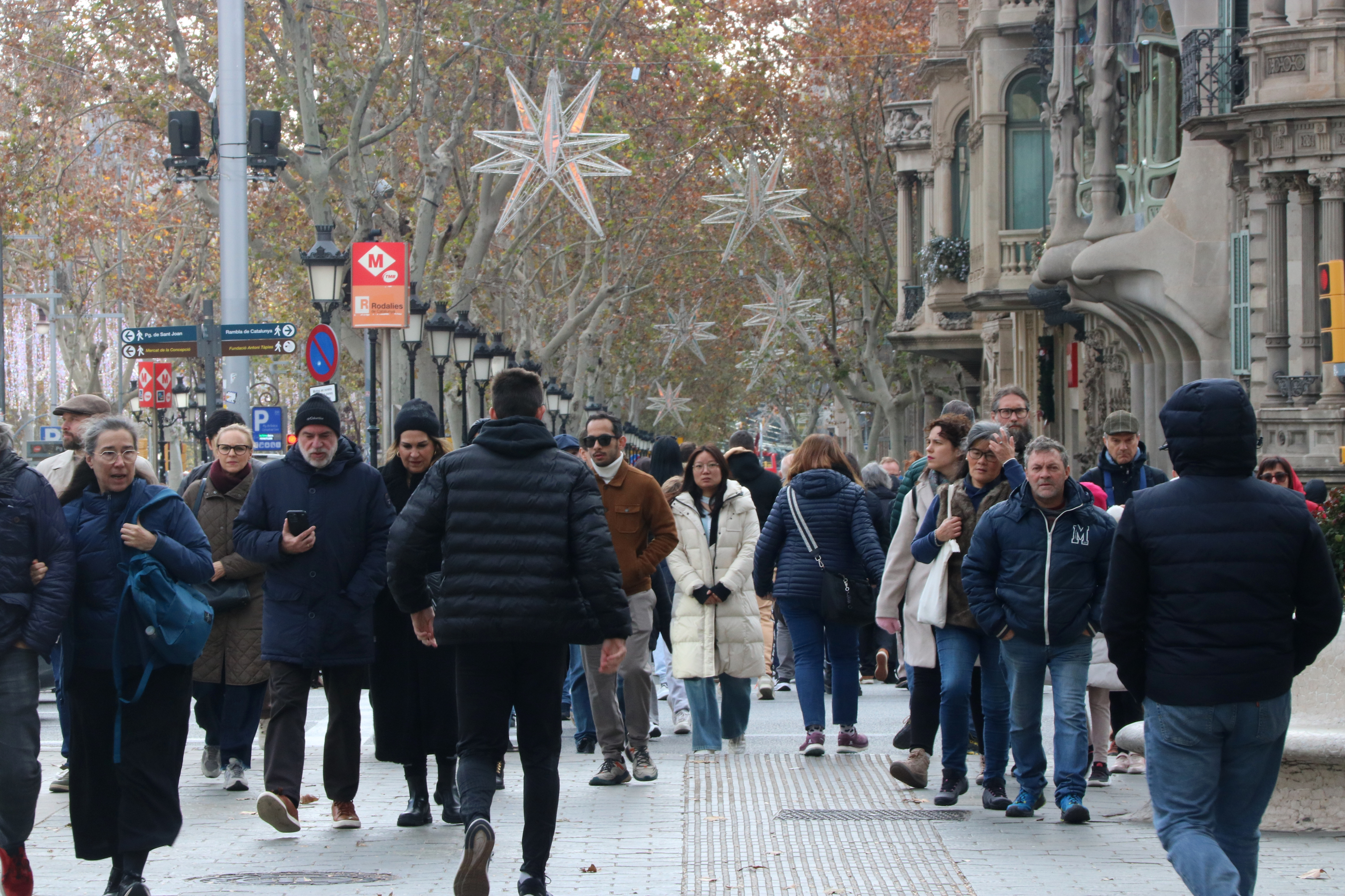 People walking through Passeig de Gràcia in Barcelona during Christmas