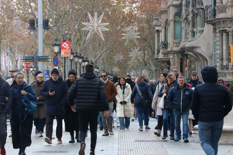 People walking around Barcelona's Passeig de Gràcia boulevard in Christmas