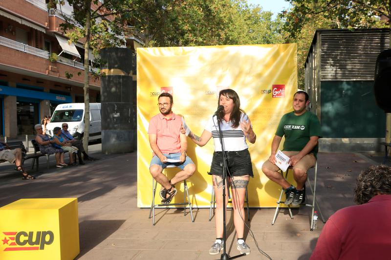 CUP candidate Laure Vega speaks at a campaign event in Santa Coloma de Gramenet alongside fellow party members Albert Botran and Aitor Blanc