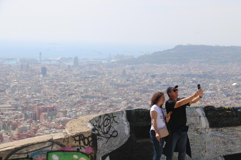 Tourists taking a selfie at the Turó de la Rovira viewpoint