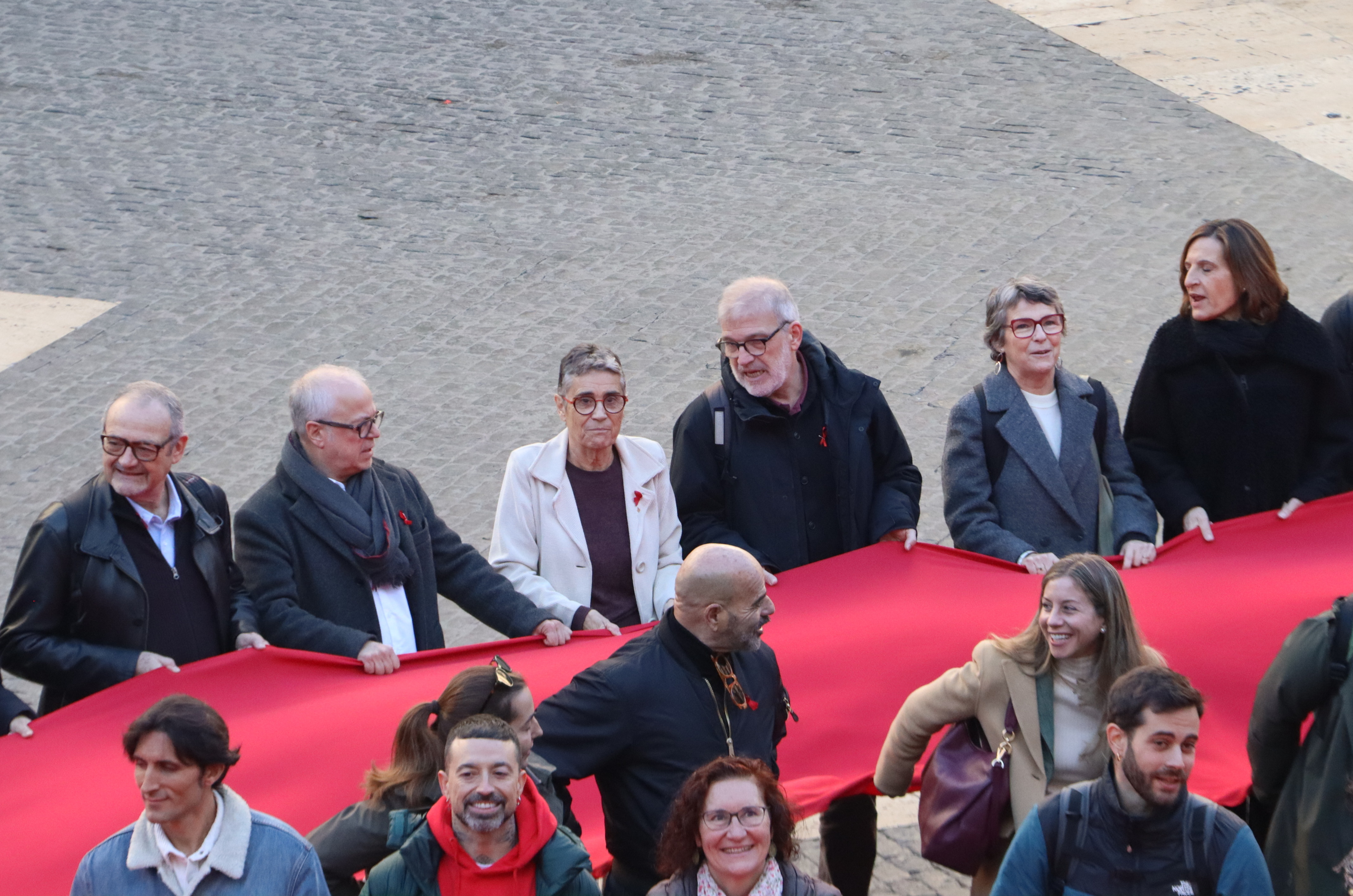 The health minister was among those carrying the red ribbon