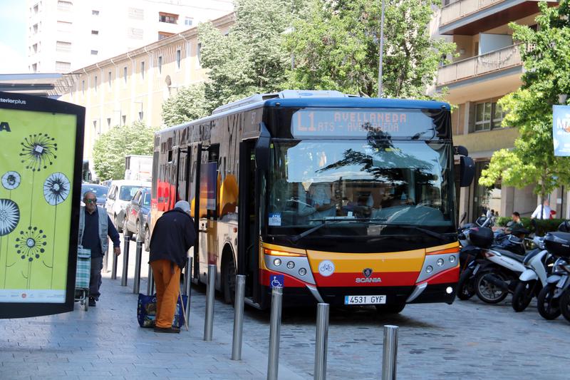 Passengers board a bus in Girona 