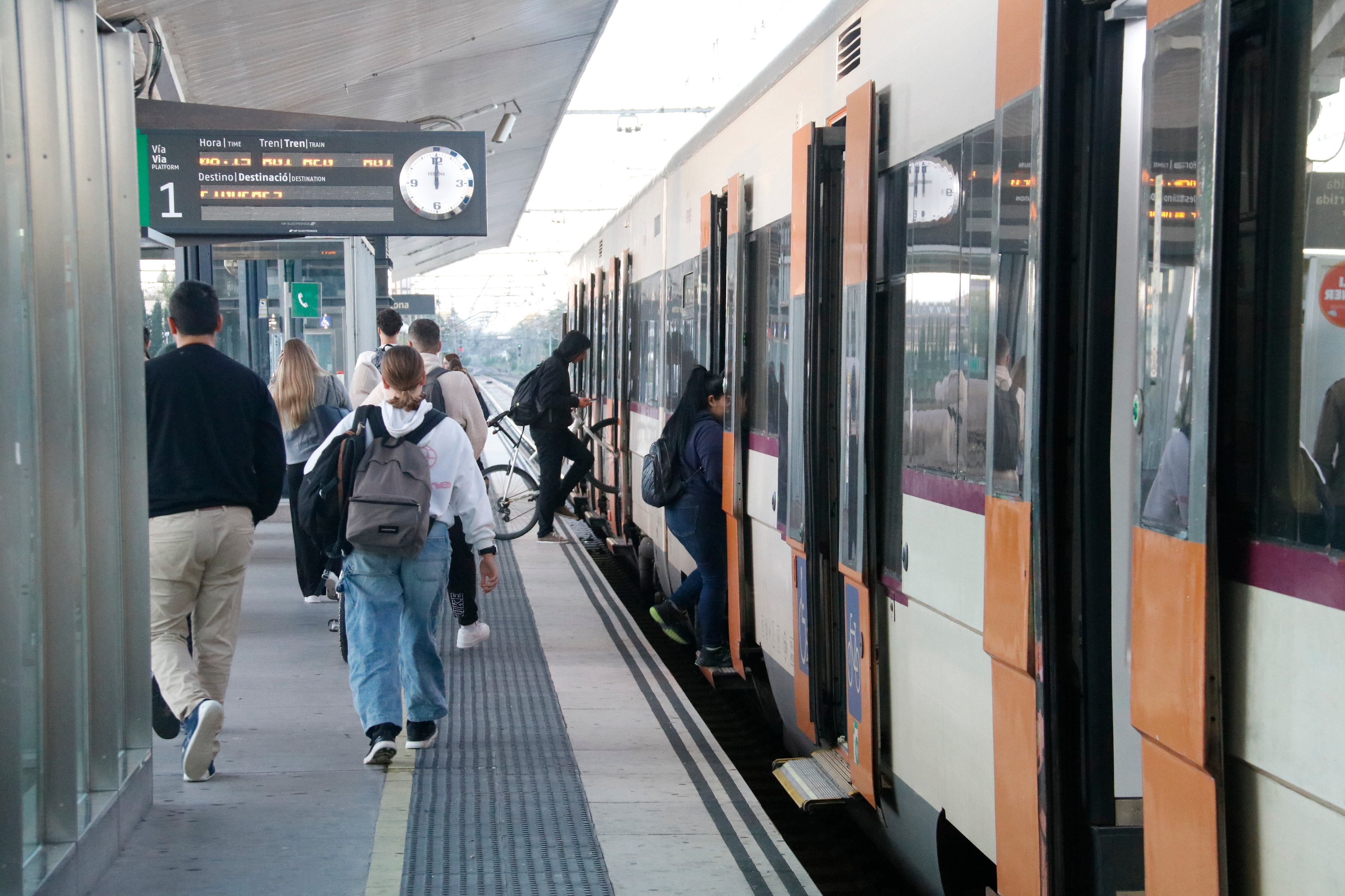 A train heading towards Figueres at the platform of Girona station.