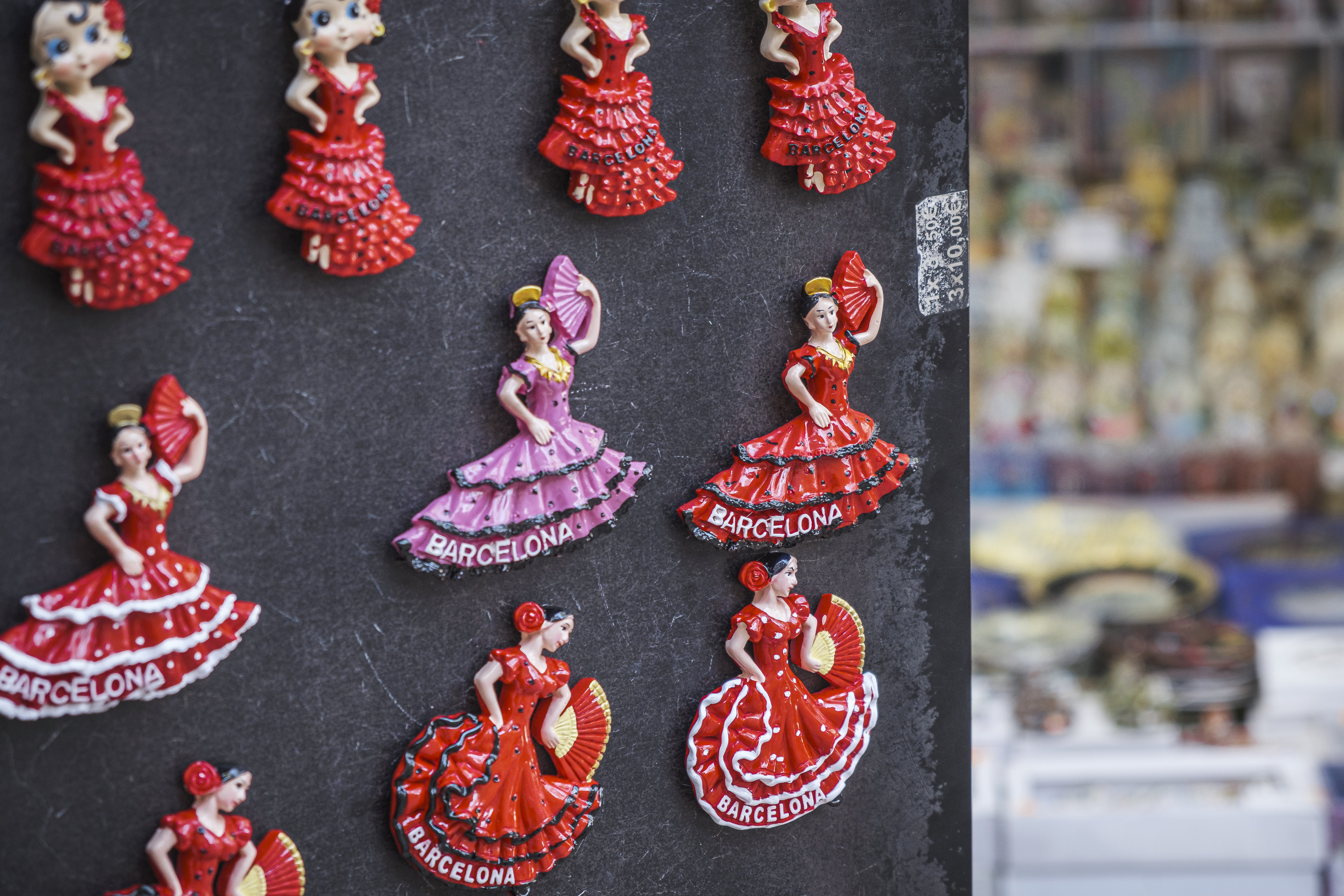 A souvenir stand in Barcelona selling a Sevillana magnet