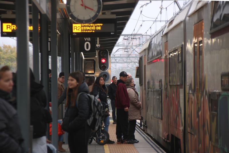 Commuters waiting to get on a train to Barcelona