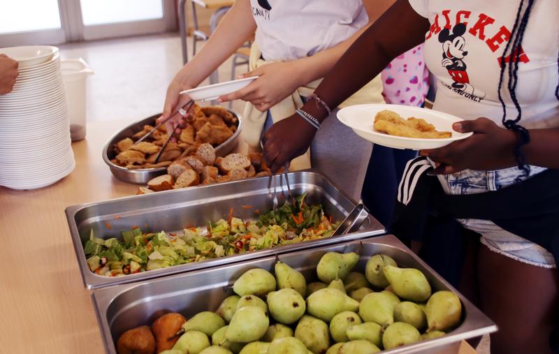 A student serves food in a school in Balenyà, in the inland county of Osona