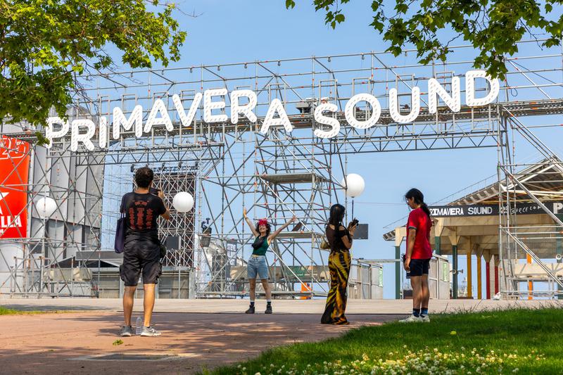Primavera Sound festival-goers taking a picture with the festival's logo at the entry of the venue