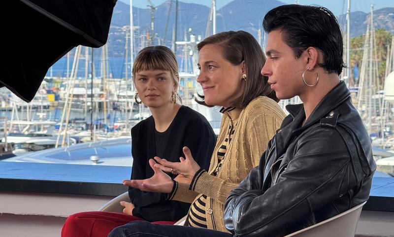 Director Carla Simón and the protagonists of 'Romería', Llúcia Garcia and Mitch, during an interview with ACN in Cannes.