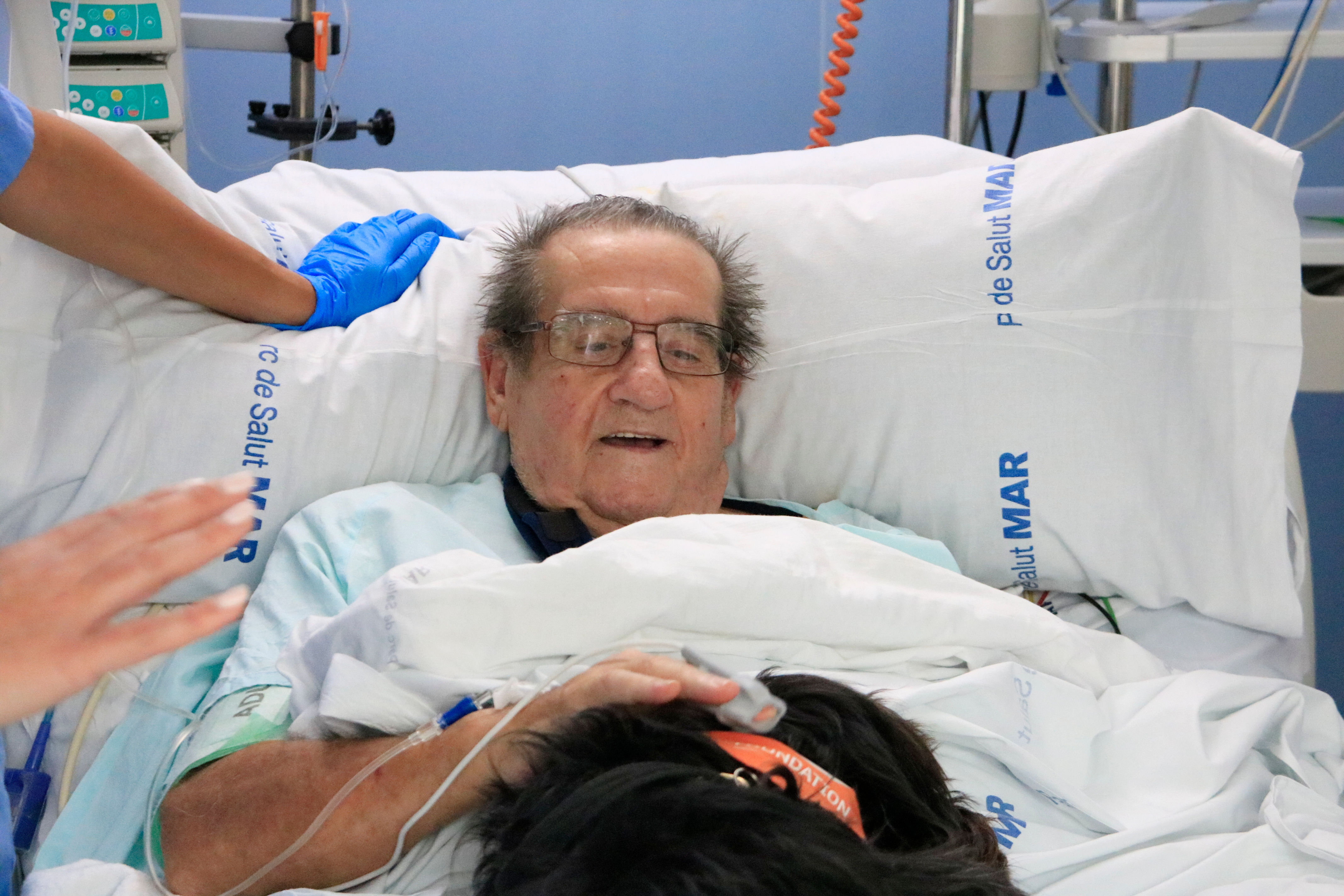 Barcelona's Hospital del Mar's ICU patient Francisco pets Vida during a therapy dog session