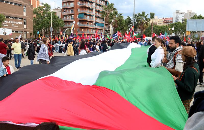 Demonstrators in Barcelona hold a huge Palestinian flag