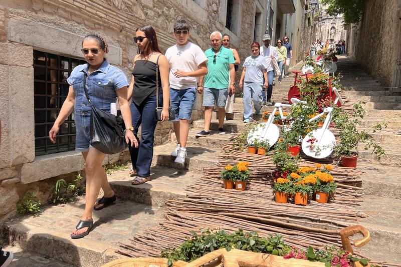 People walk alongside one of the Temps de Flors installations, on the last day of the 70th edition