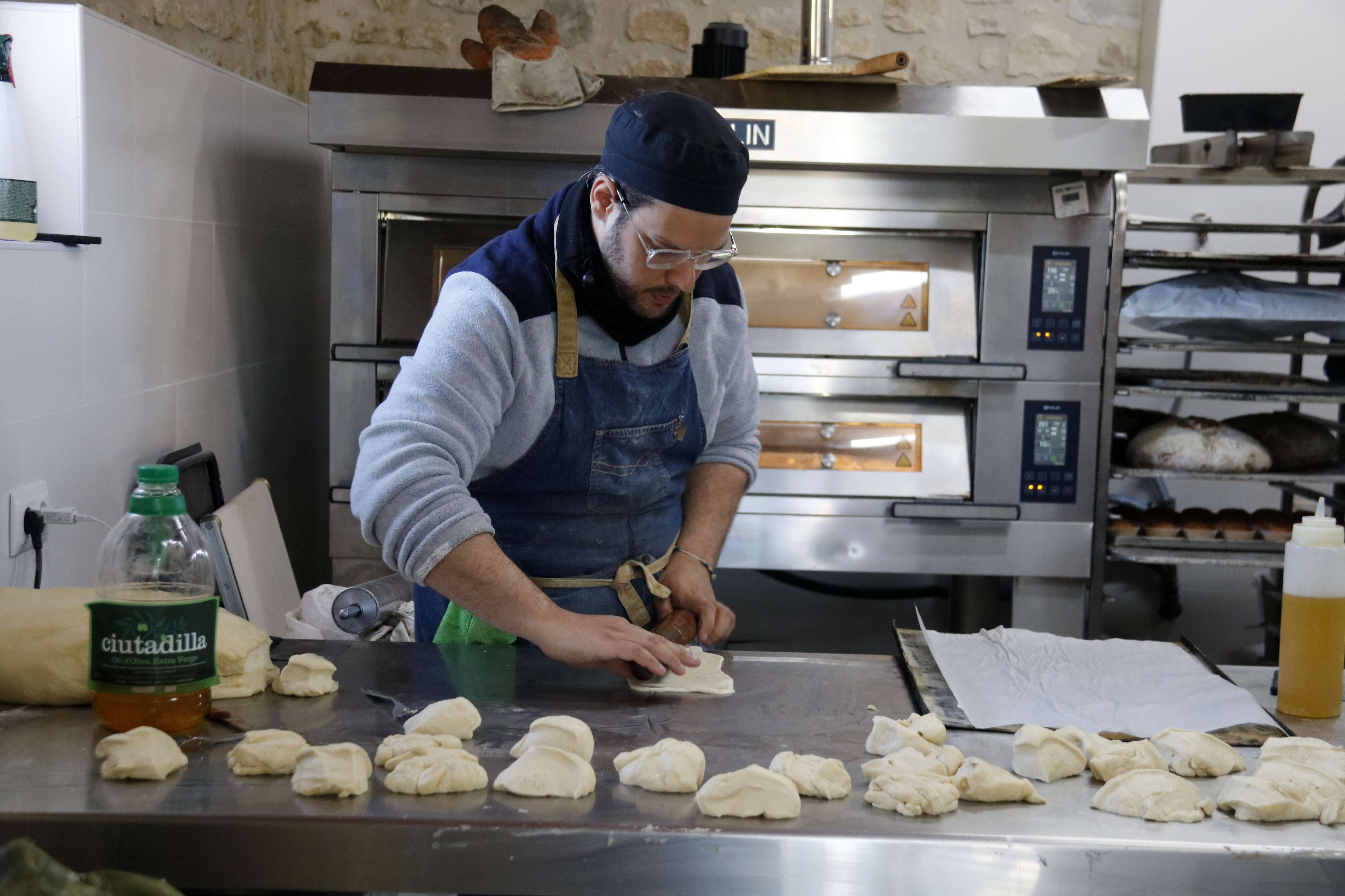 The 'Pont de Sucre' baker stretching cookie dough in the workshop