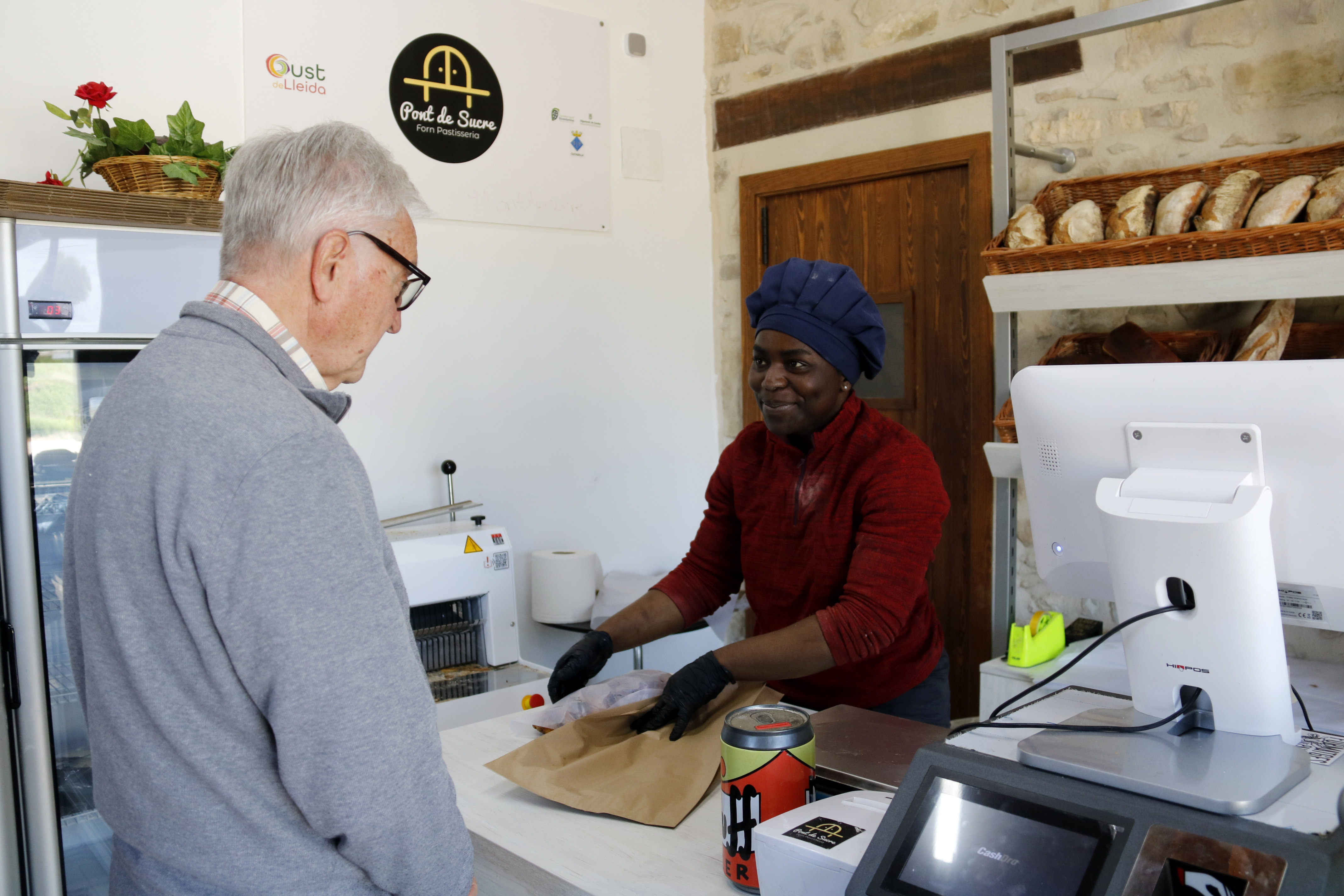 Baker Lydia Karikari prepares an order at the new Ciutadilla bakery