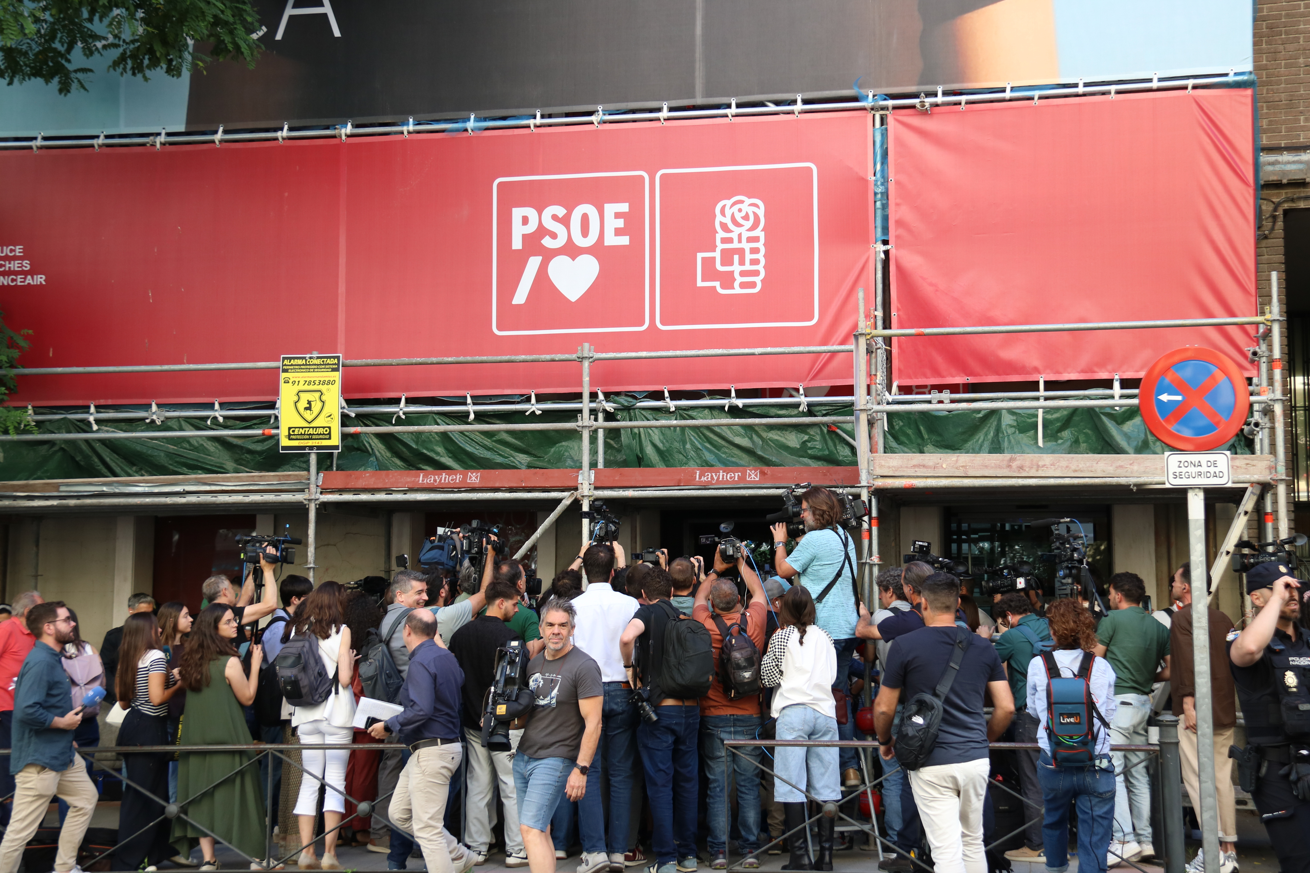 Journalists outside the Socialists' headquarters on Ferraz Street in Madrid
