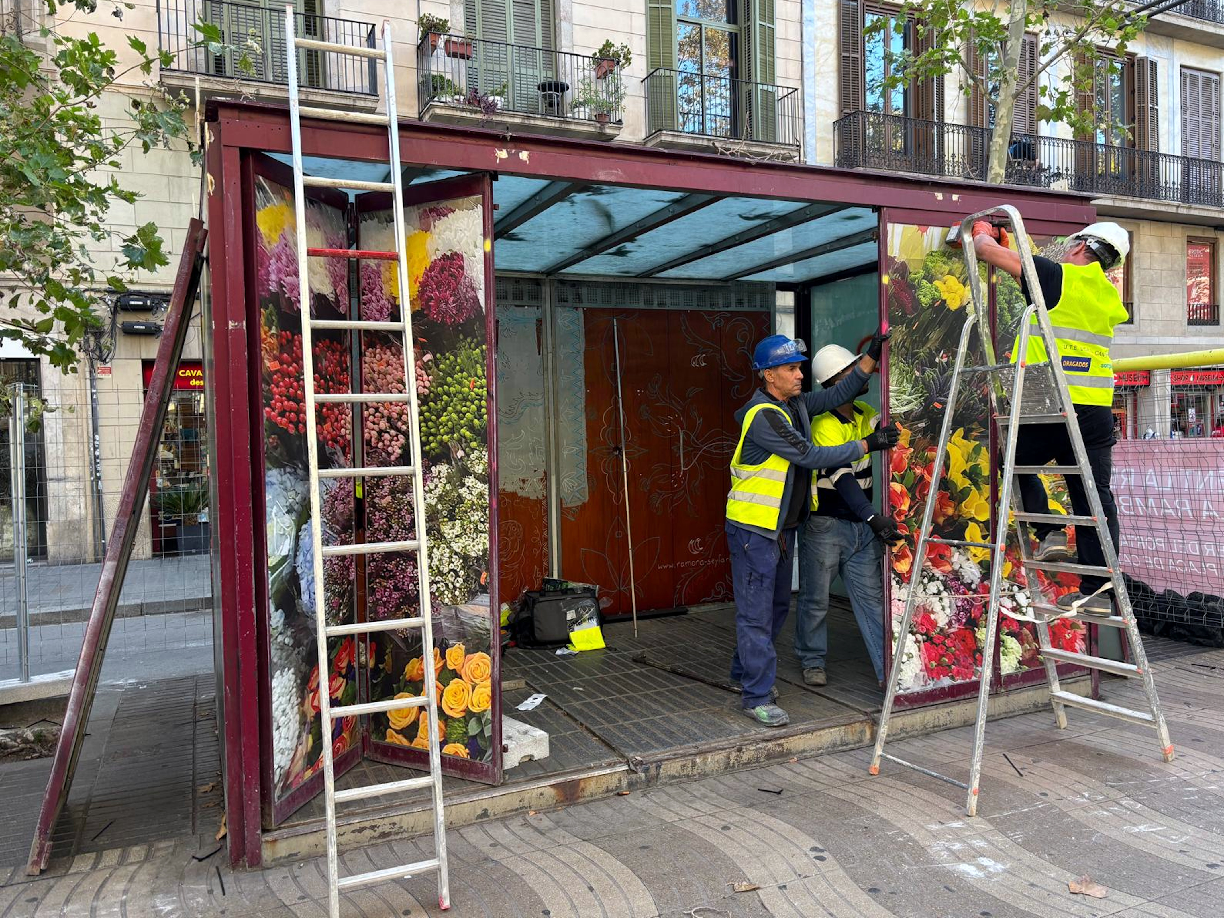 Workers disassemble one of the 'old bird shops' or 'ocellaires' stalls in Barcelona's famous La Rambla boulevard on October 22, 2024