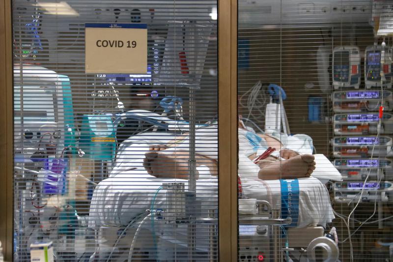 A Covid-19 patient lies in an ICU ward in a hospital in Catalonia
