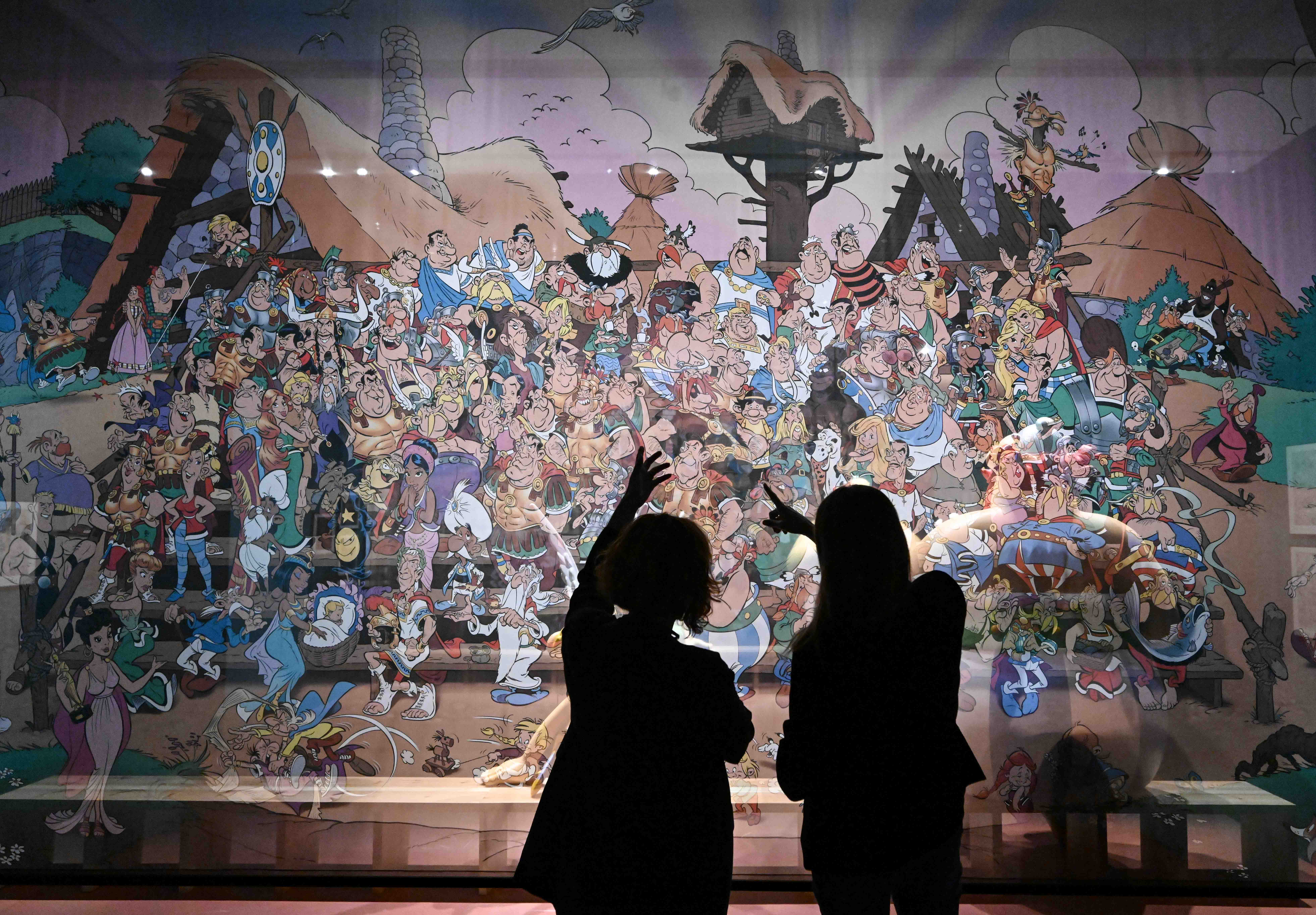 Visitors browse one of the more than 300 items on display at the Comic exhibition in the CaixaForum