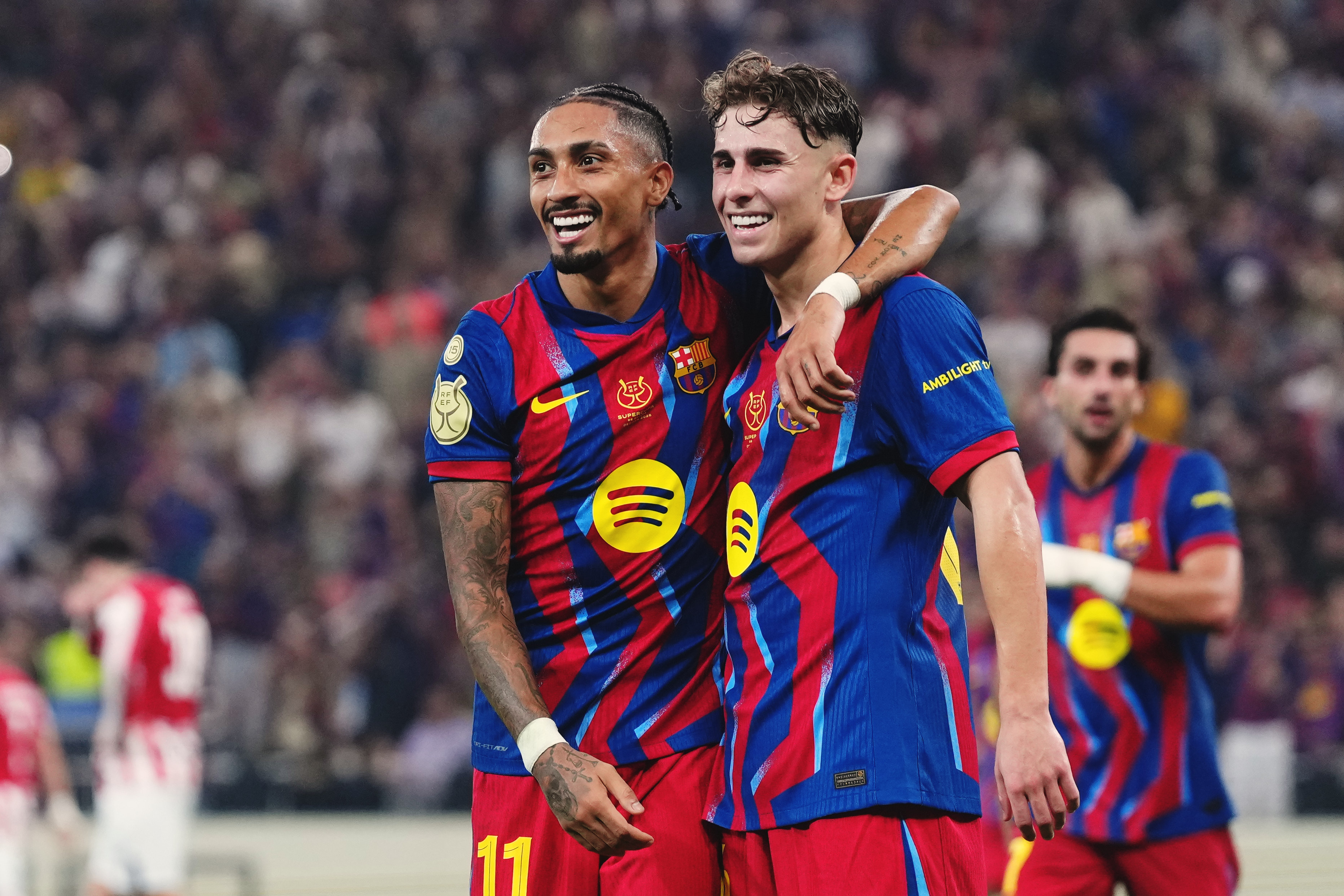 FC Barcelona's Fermín and Raphinha celebrate after scoring against Athletic Club in the Supercopa de España semifinal