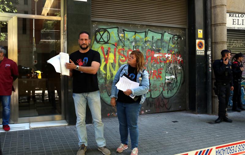 Prison workers Gabriel and Francina show their 2,700 prison staff signatures in front of the Esquerra Republicana de Catalunya party headquarters in Barcelona on May 8, 2024