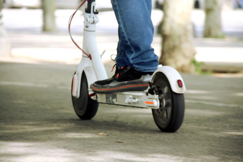 Close-up of feet on an electric scooter - Courtesy of ACN