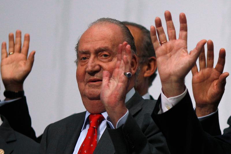 Former Spanish king, Juan Carlos, waves during a group photo with Ibero-American leaders during the Ibero-American Summit in Cadiz