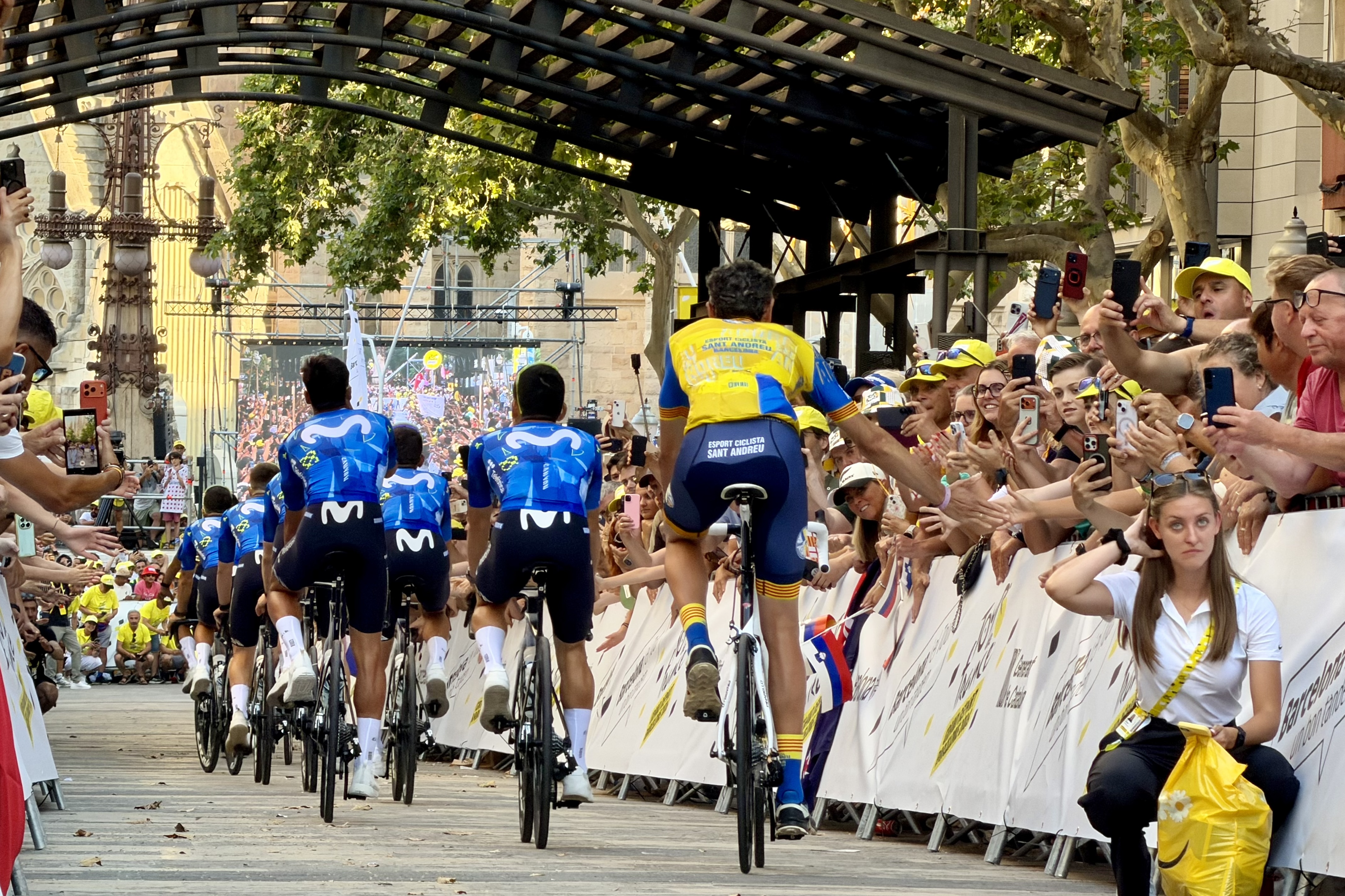 A cyclist greets fans in the streets of Barcelona, ??at the presentation of Tour de France teams.