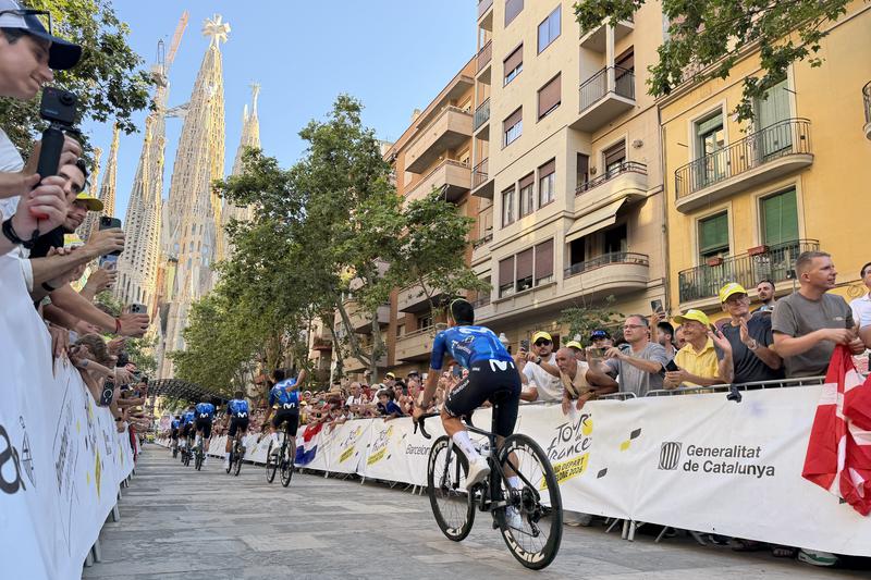 Tour de France riders approach the Sagrada Família