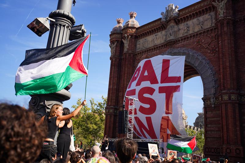 A large poster hanging from Barcelona's Triumphal Arch reads 'Palestina' during a pro-Palestine rally in the Catalan capital