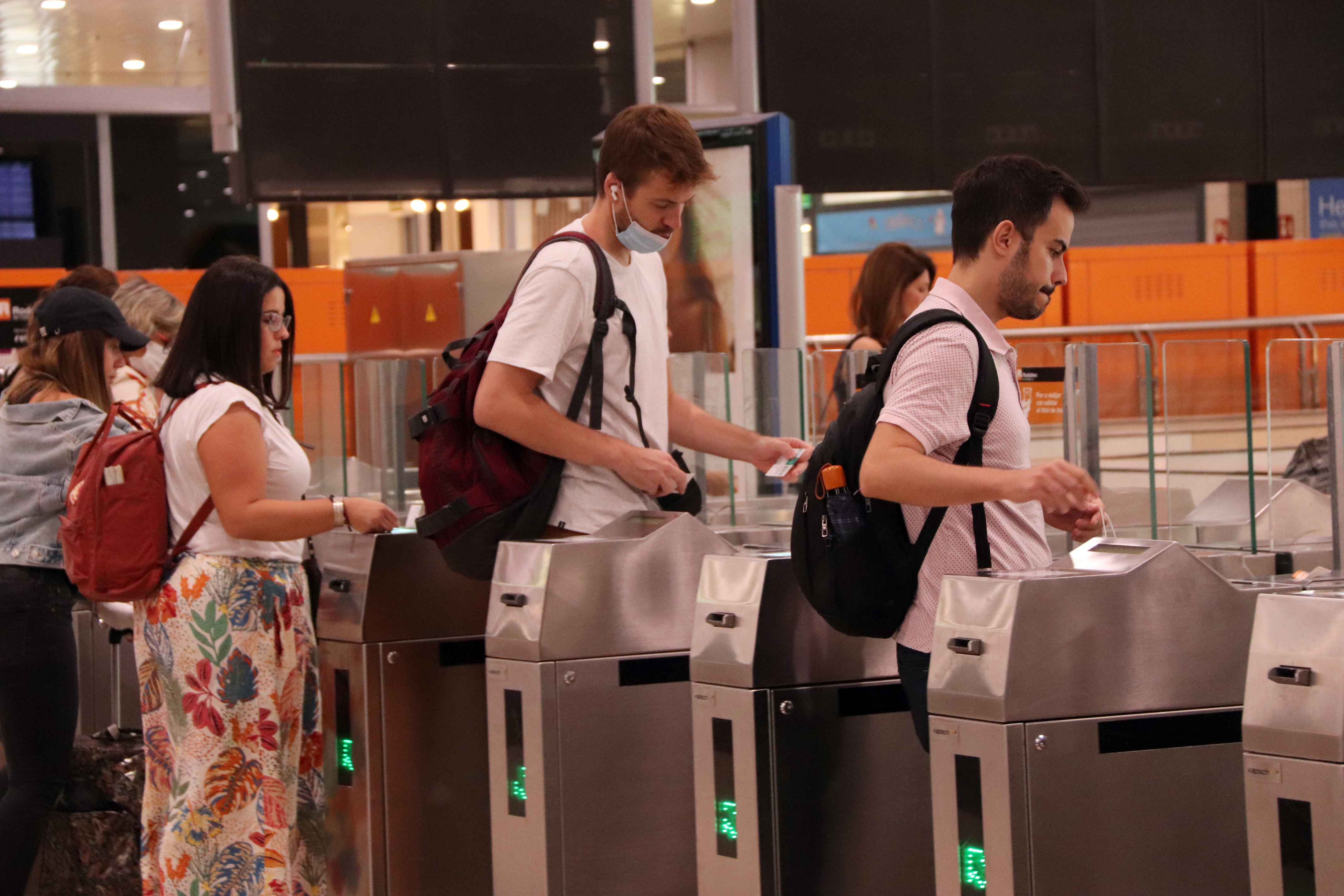 Commuters validating their Rodalies ticket on September 1, 2022