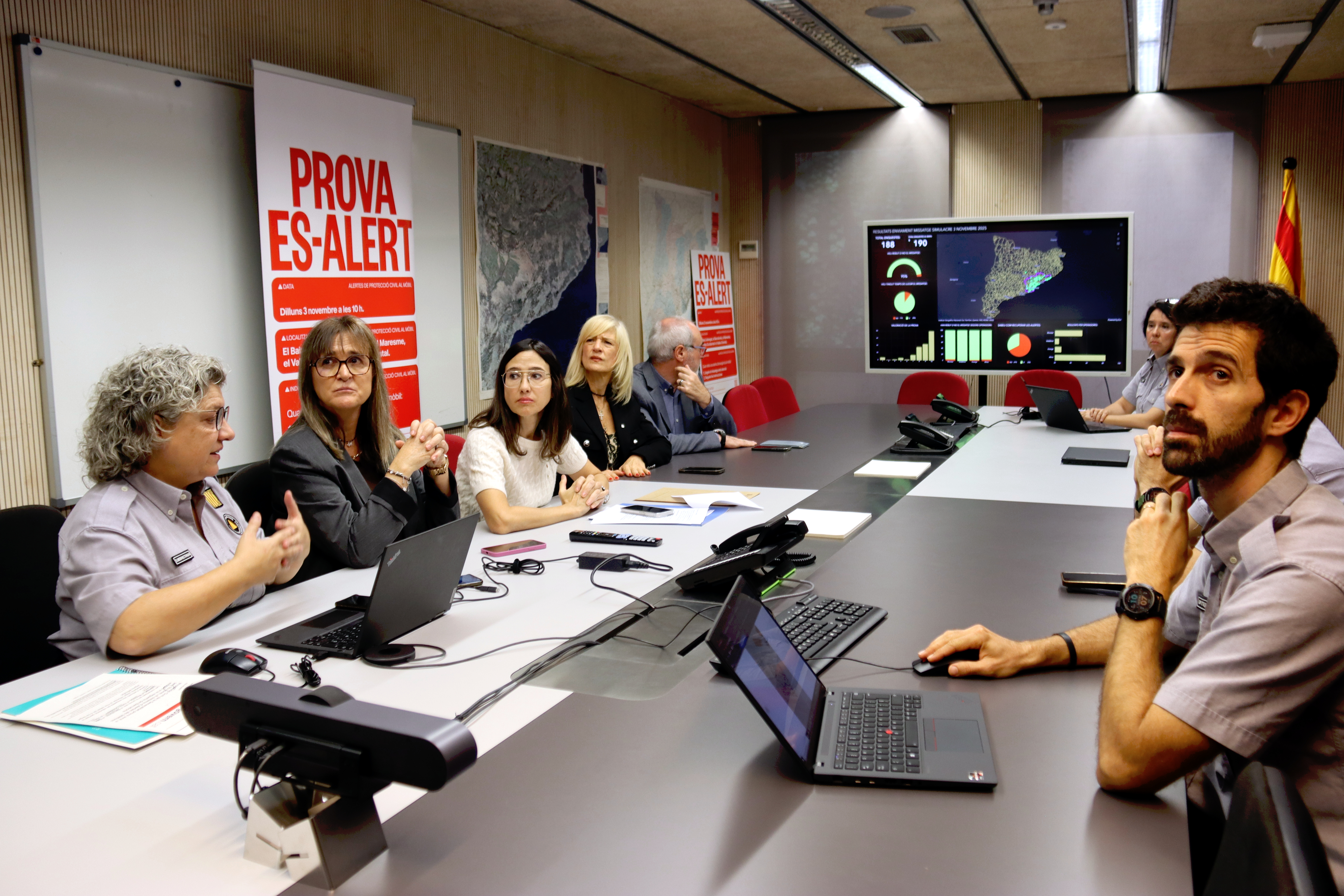 Interior Minister Núria Parlon and other officials monitor the emergency alert being sent to mobile phones across the greater Barcelona area