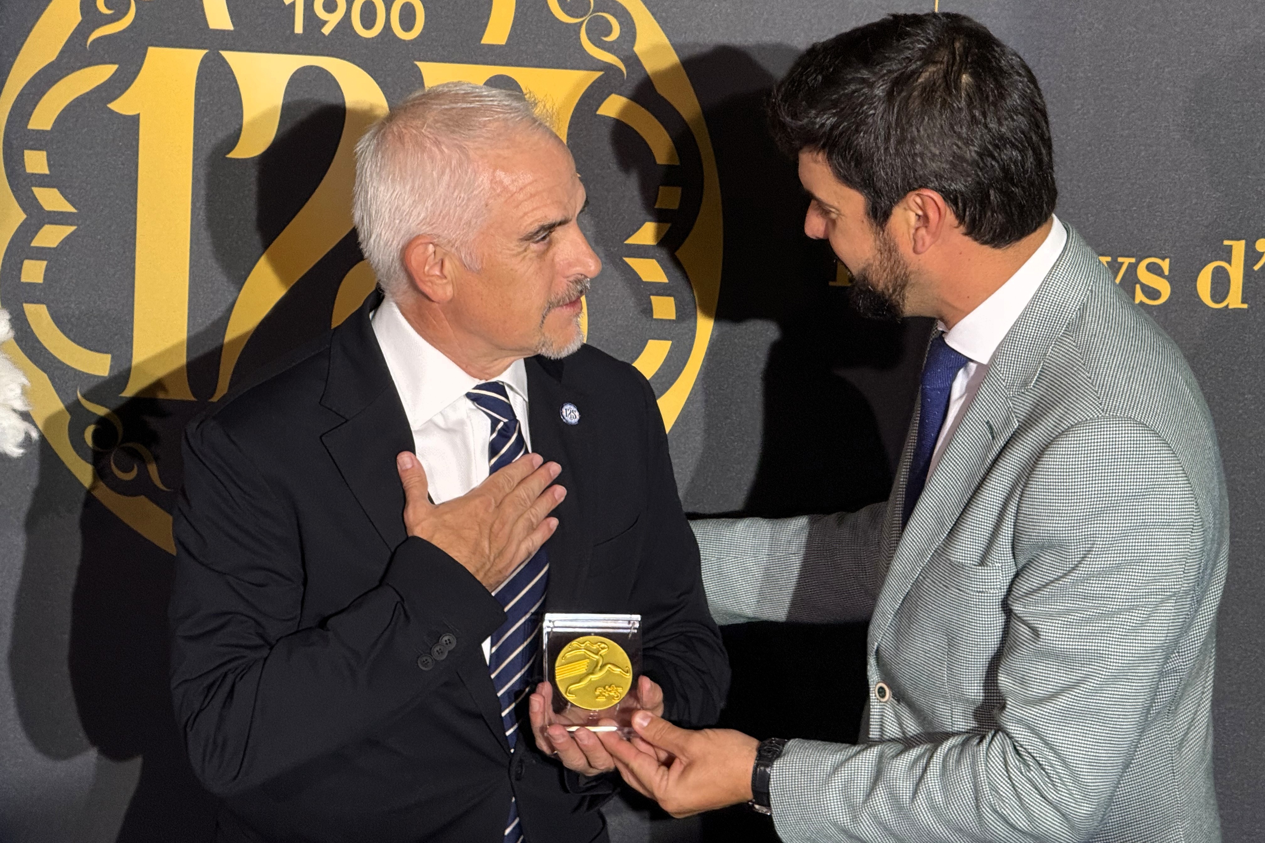 Espanyol president Alan Pace is presented with a commemorative medal