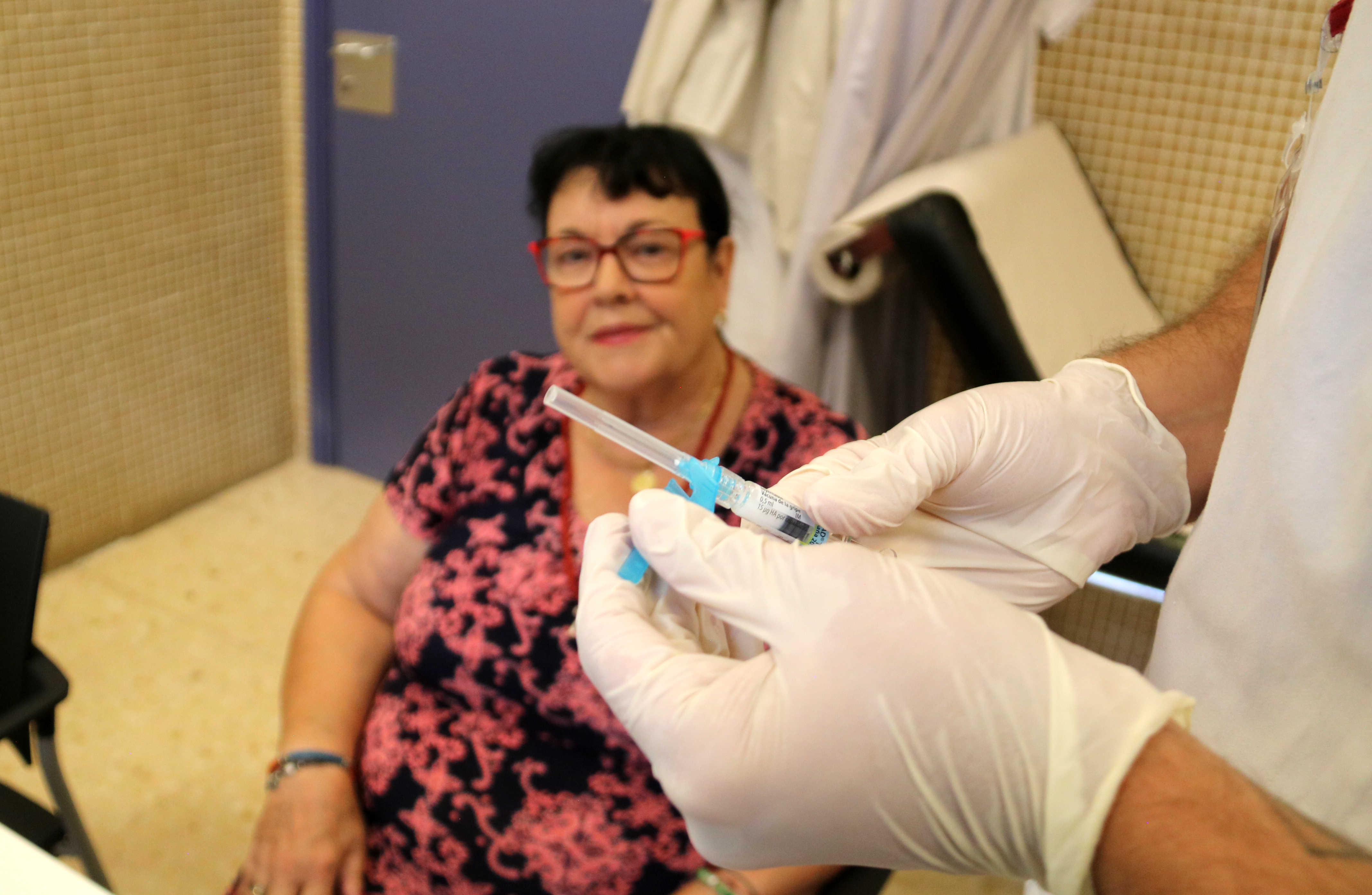 A woman waits to get a flu vaccine in the Baix Ebre de Tortosa primary care centre