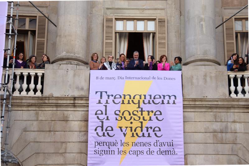 Barcelona councilors unveil a banner on the city hall building to mark International Women's Day