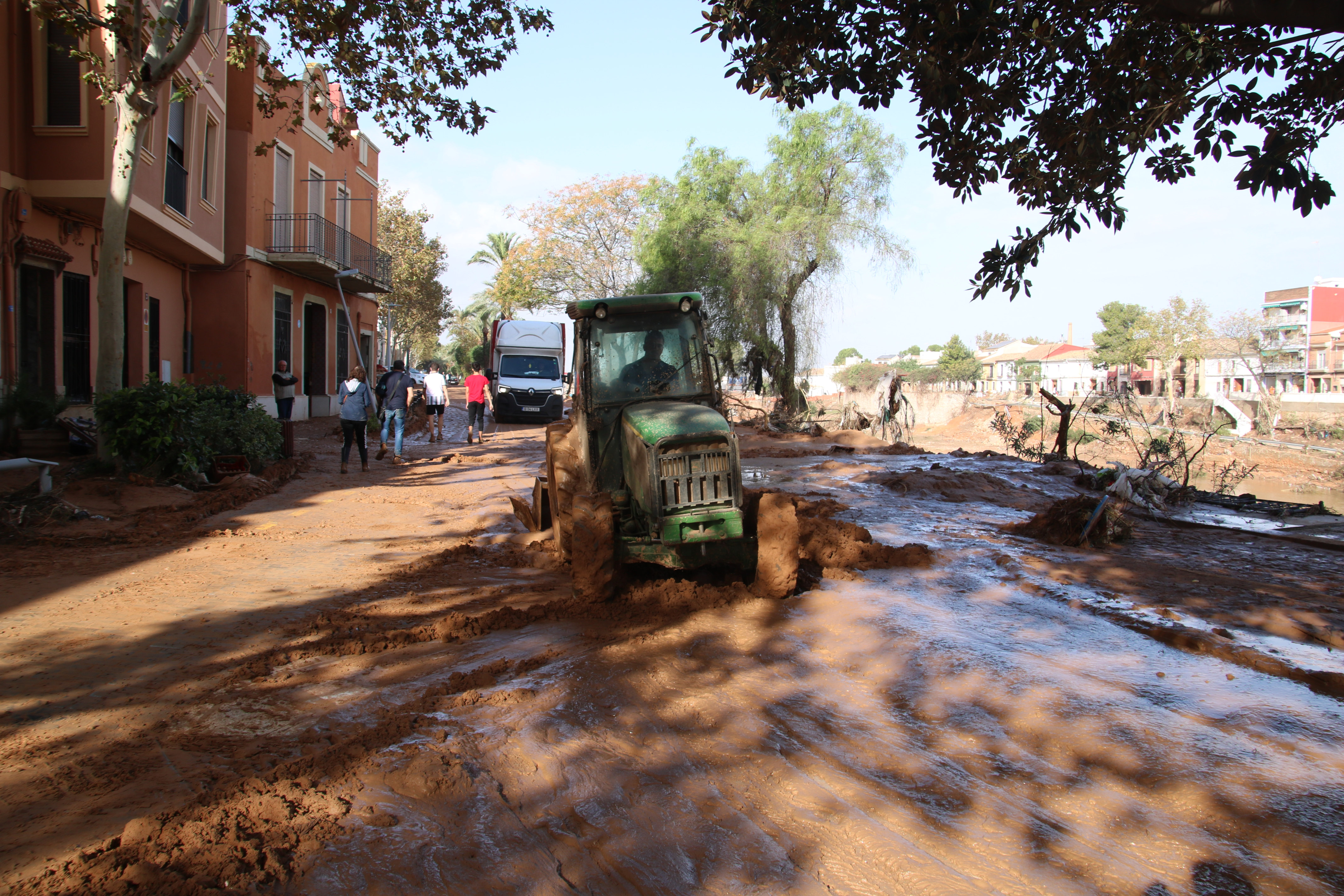 A tractor works to clean roads in Picanya