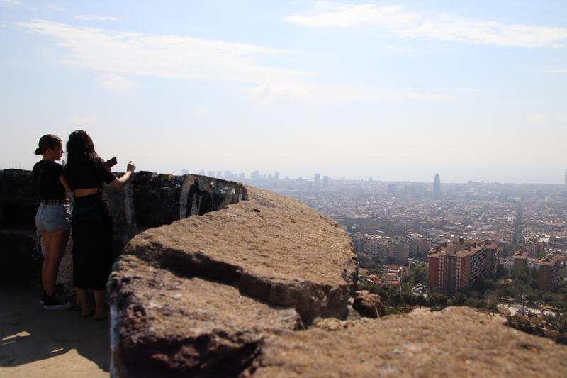 Tourists look out at the city of Barcelona