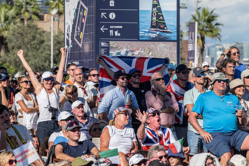 A group of America's Cup supporters follow the race on September 28, 2024 from one of the giant screens set in Barcelona