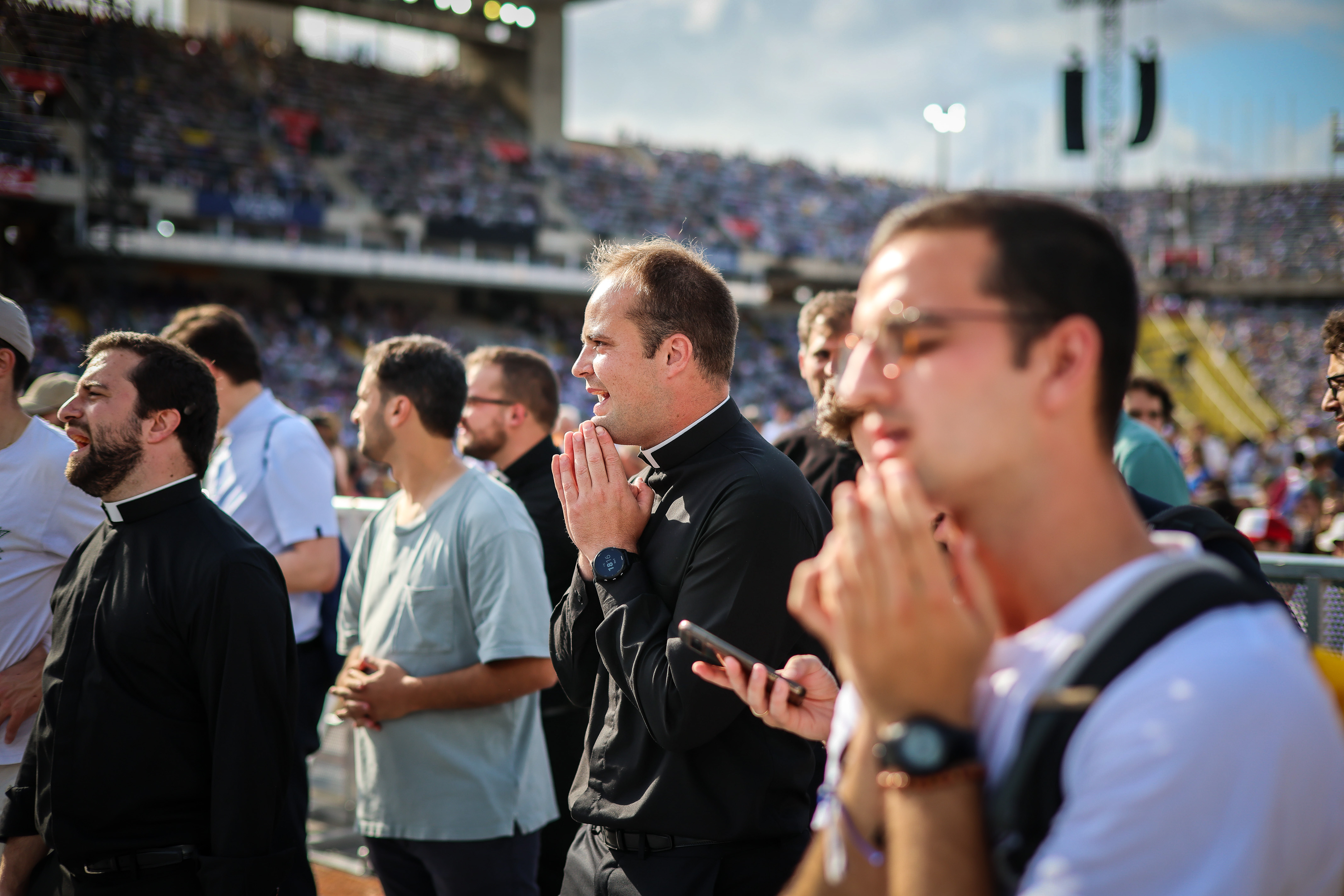 Chaplains listen to musical performances at the Olympic Stadium