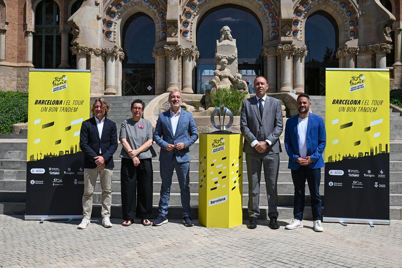 Barcelona mayor Jaume Collboni poses with the Tour de France trophy alongside other members of the city council