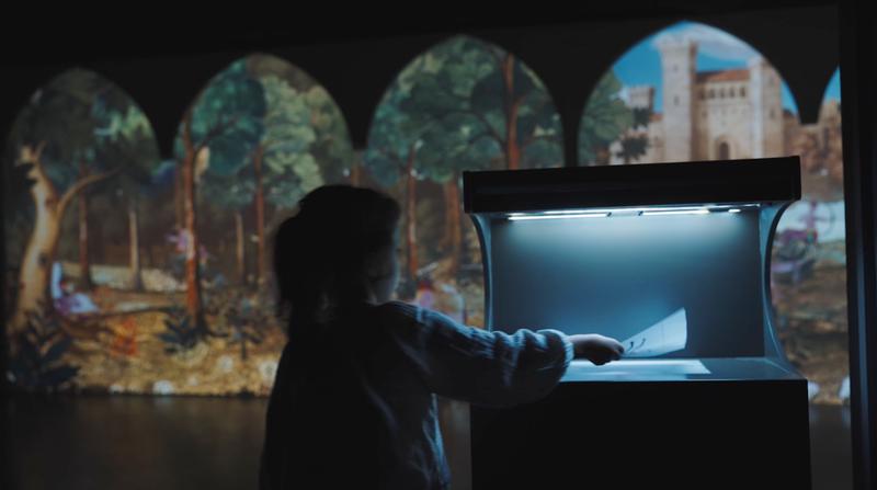 A child enjoying activities at the Library of Fantastic Beasts exhibition in Casa Amatller