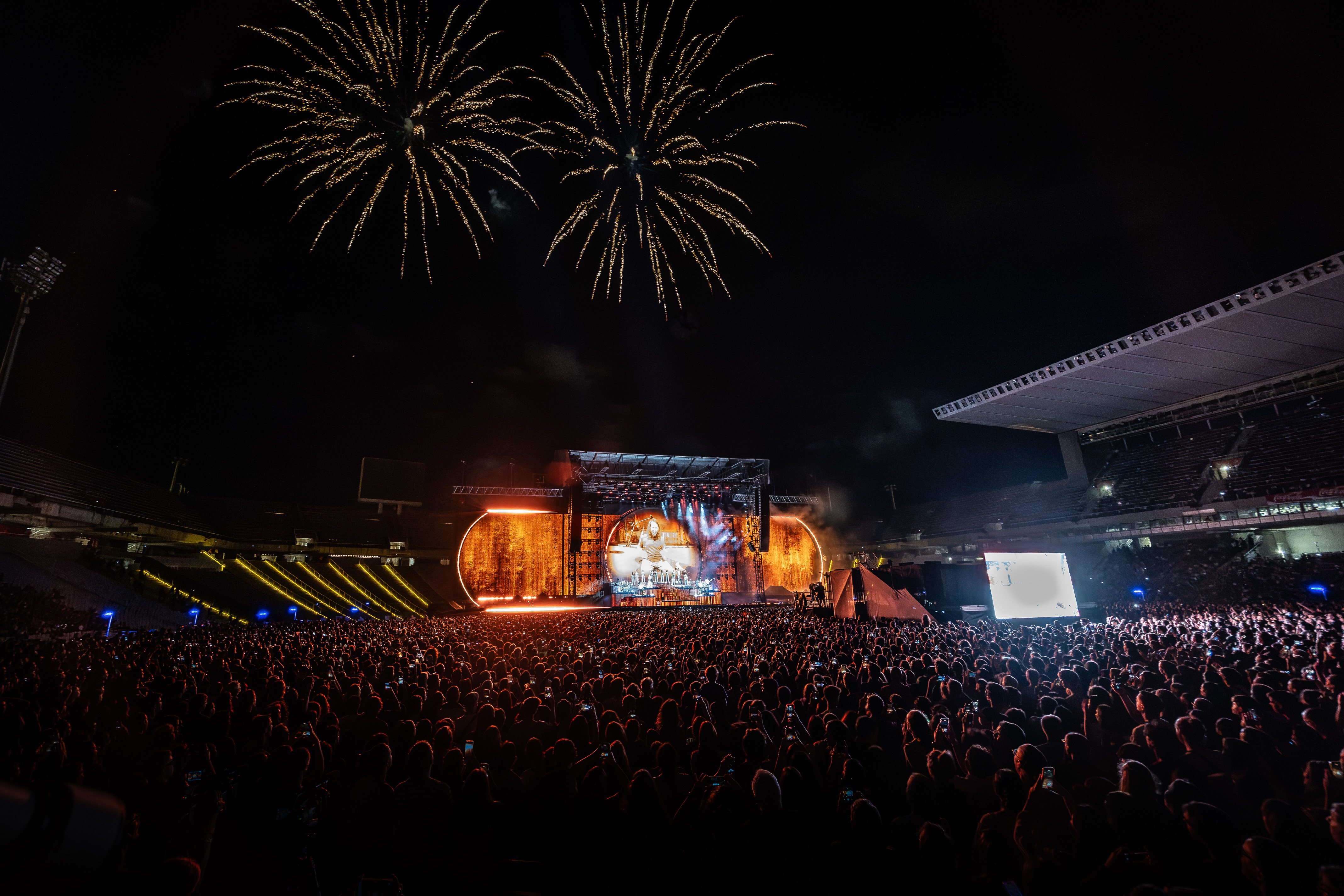 A moment from the first of Oques Grasses' four farewell concerts at the Lluís Companys Olympic Stadium, with fireworks in the sky.